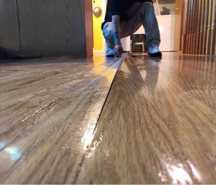 Close up of water damage on a wood floor