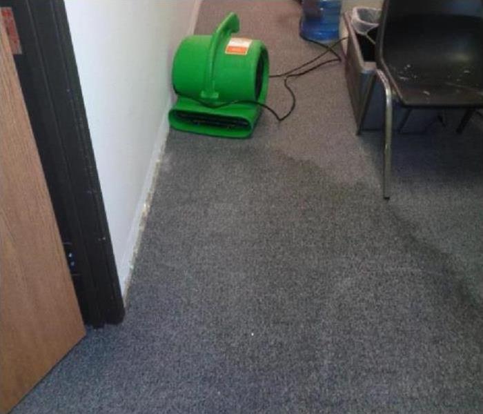 Wet carpet with drying equipment.
