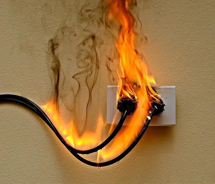 Cord in outlet on fire.
